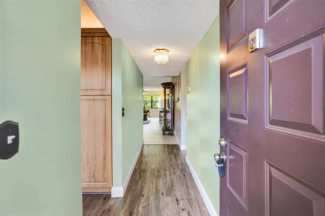 a view of a dining room with furniture a chandelier and wooden floor