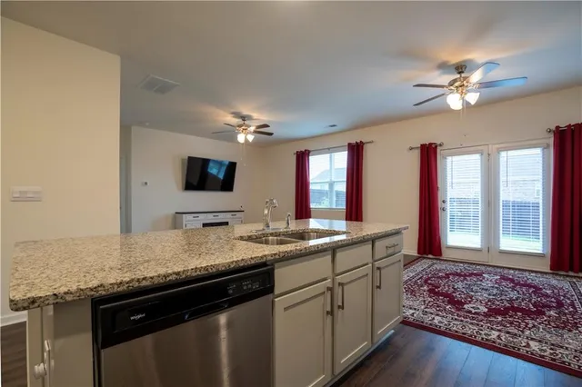 a bathroom with a granite countertop sink a large mirror and a window