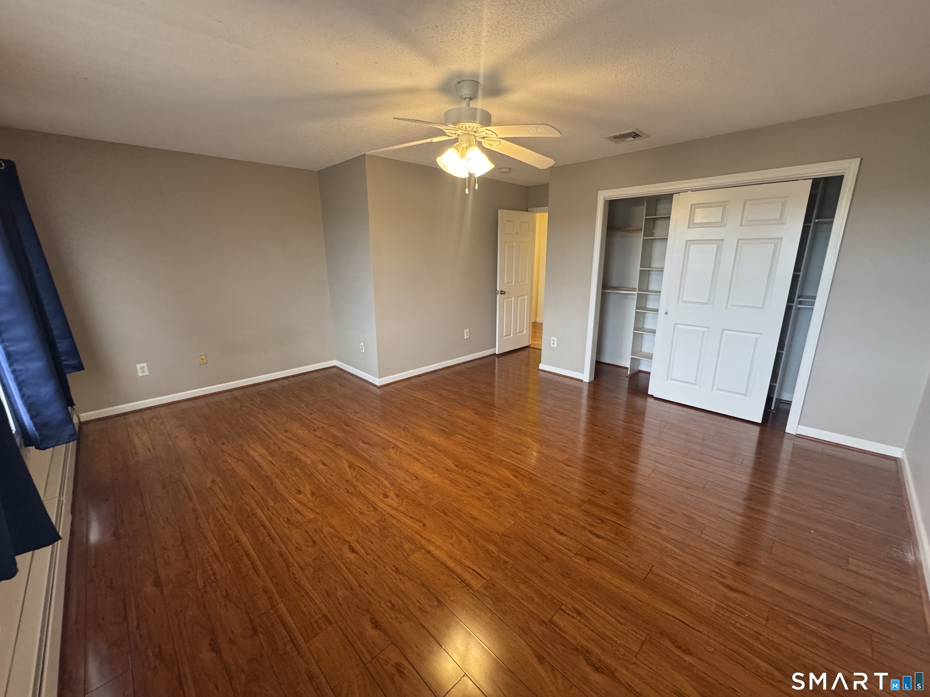 32 Tyler Hill Road Naugatuck, CT 06770 - Photo 21 of 27 a view of an empty room with wooden floor and a ceiling fan