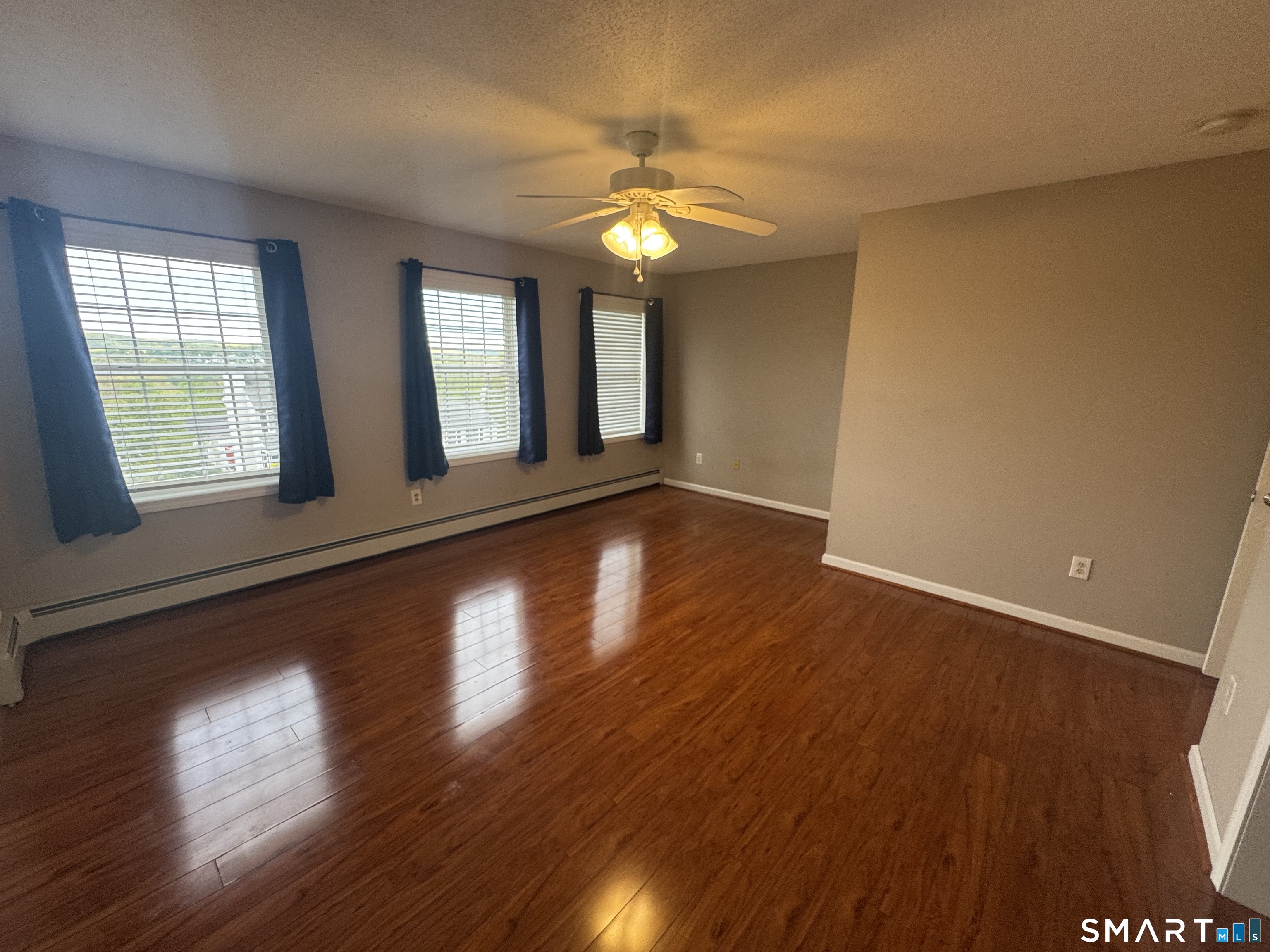 32 Tyler Hill Road Naugatuck, CT 06770 - Photo 22 of 27 a view of an empty room with wooden floor and a window