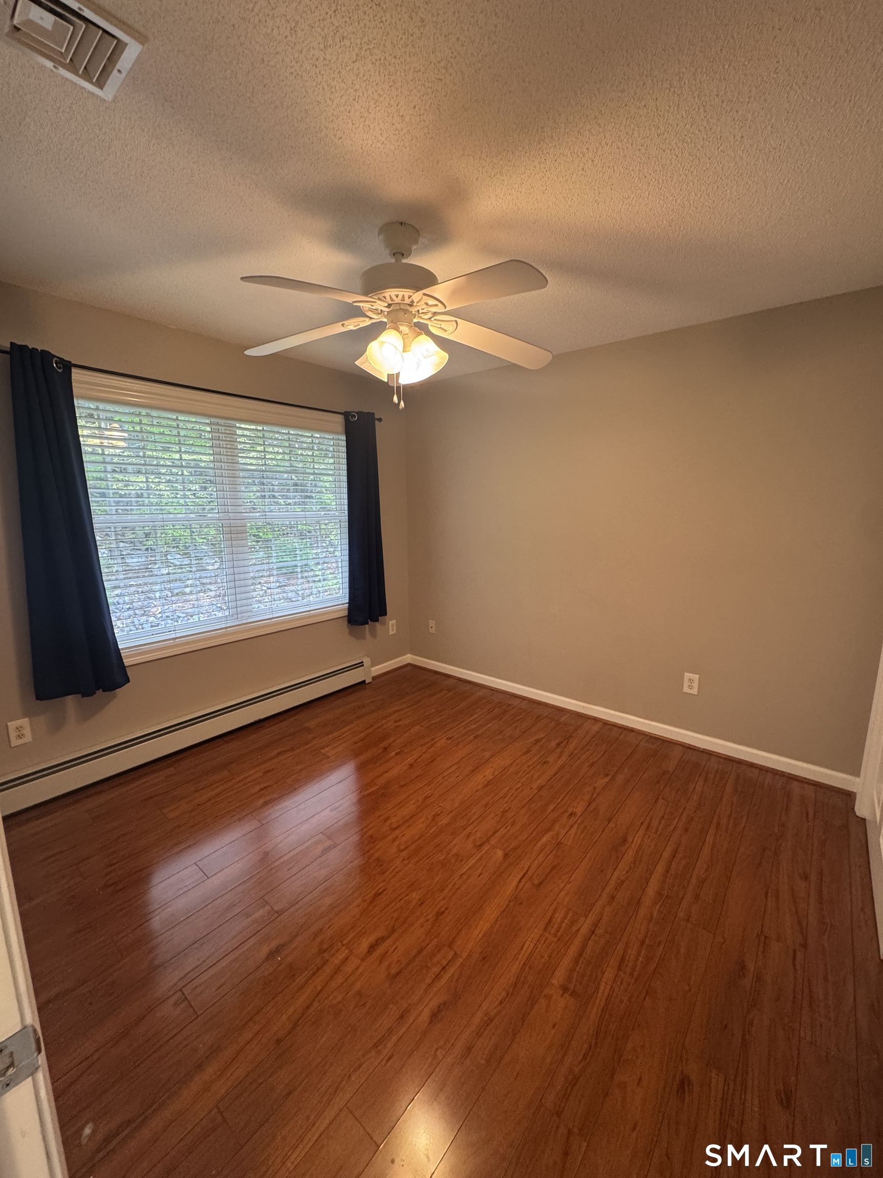 32 Tyler Hill Road Naugatuck, CT 06770 - Photo 24 of 27 an empty room with wooden floor and windows