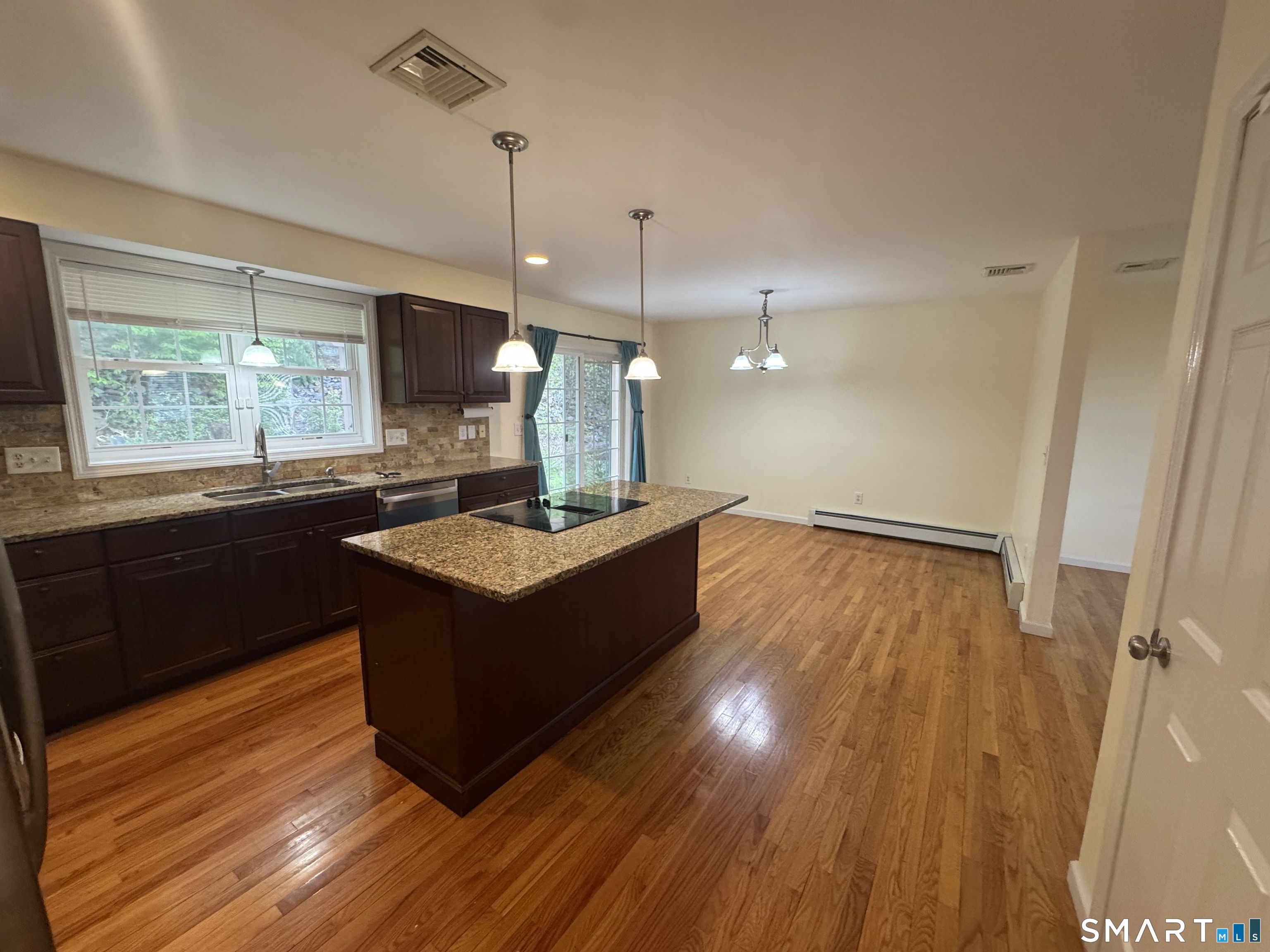 32 Tyler Hill Road Naugatuck, CT 06770 - Photo 3 of 27 a kitchen with a sink window and wooden floor