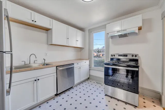 a kitchen with a sink stove and cabinets