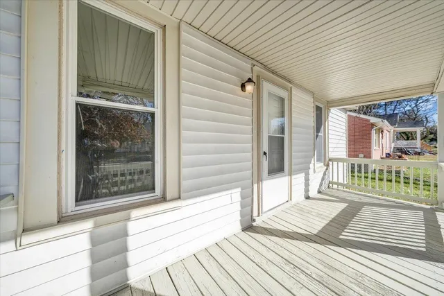 a view of a balcony with wooden floor