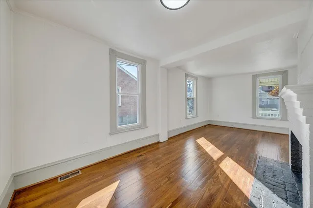 a view of a room with wooden floor and window