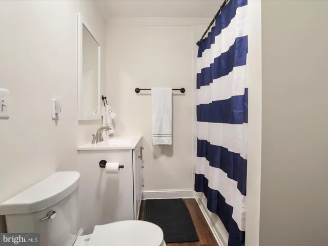 a bathroom with a sink and mirror with toilet