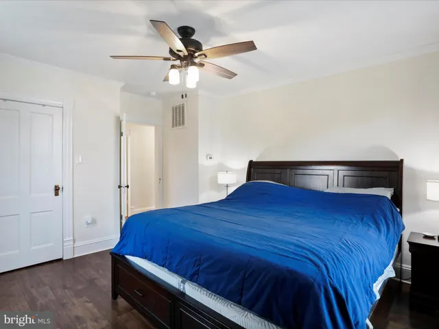 a bedroom with a bed and a ceiling fan