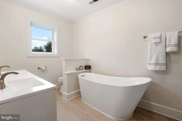 a white bath tub sitting in a bathroom