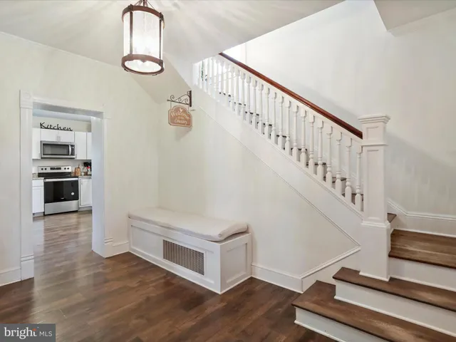 a view of entryway and hall with wooden floor
