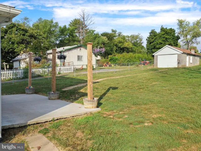 a view of a house with a yard and sitting area