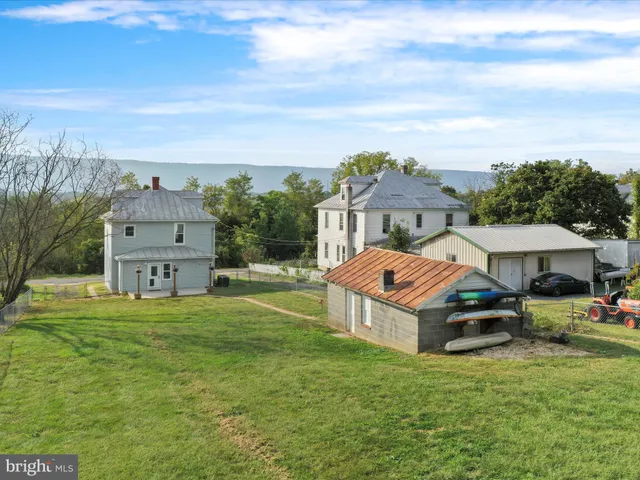 an aerial view of a house with a big yard