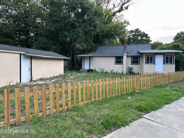a front view of house with yard and green space