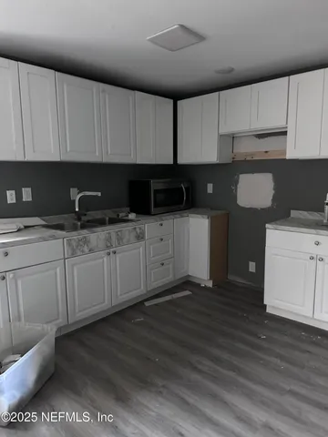 a kitchen with a sink a stove and cabinets