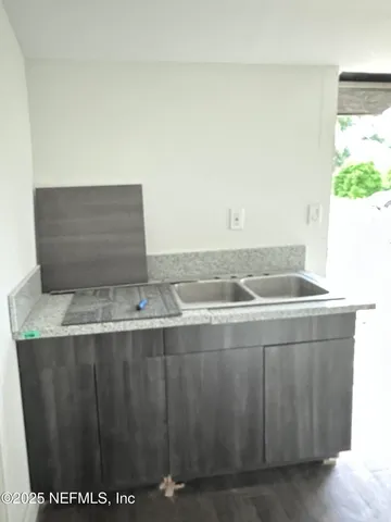 a view of a kitchen cabinets and a counter top space