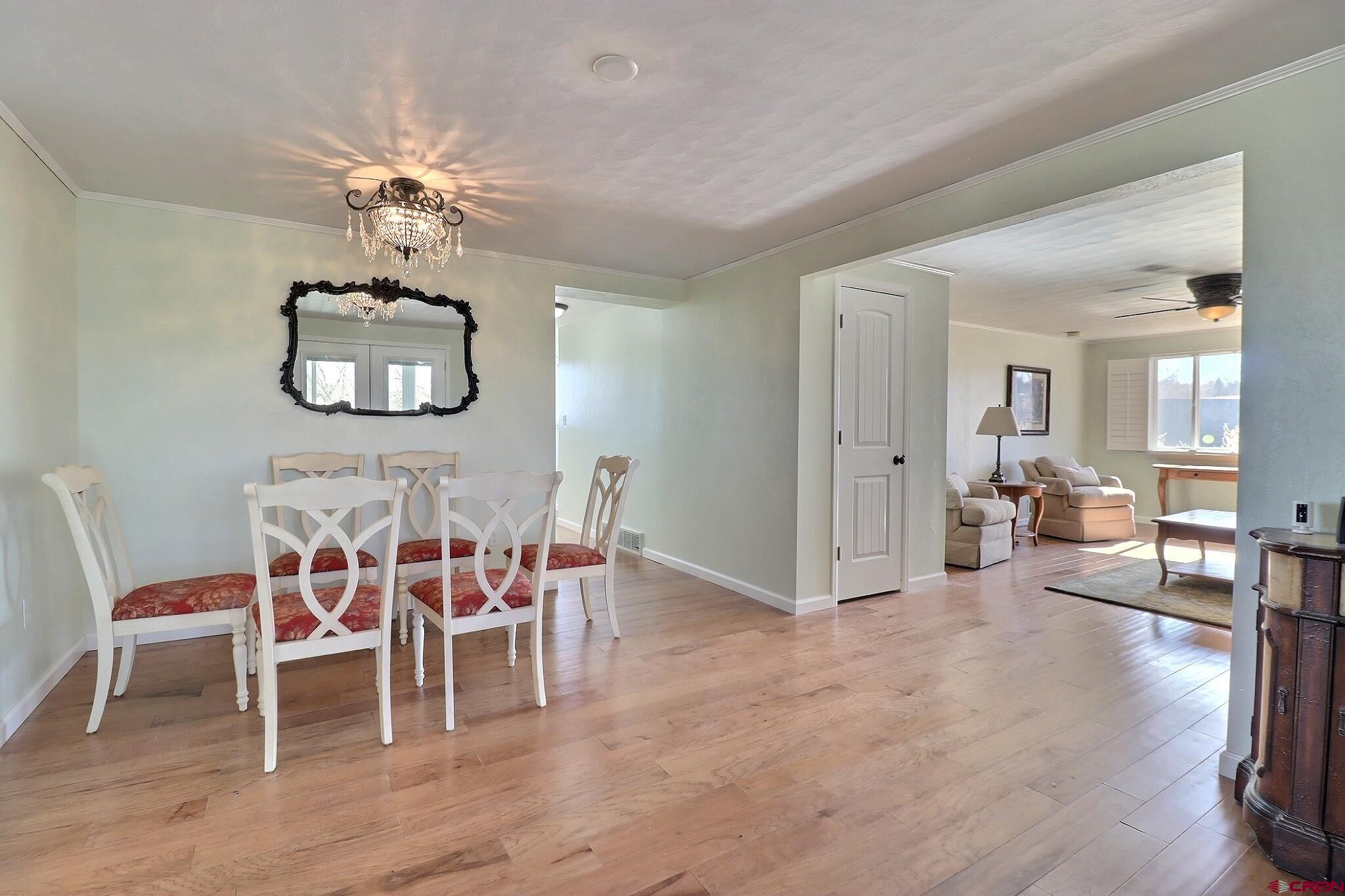 36557 Grandview Mesa Road Crawford, CO 81415 - Photo 14 of 45 a dining room with furniture a chandelier and wooden floor