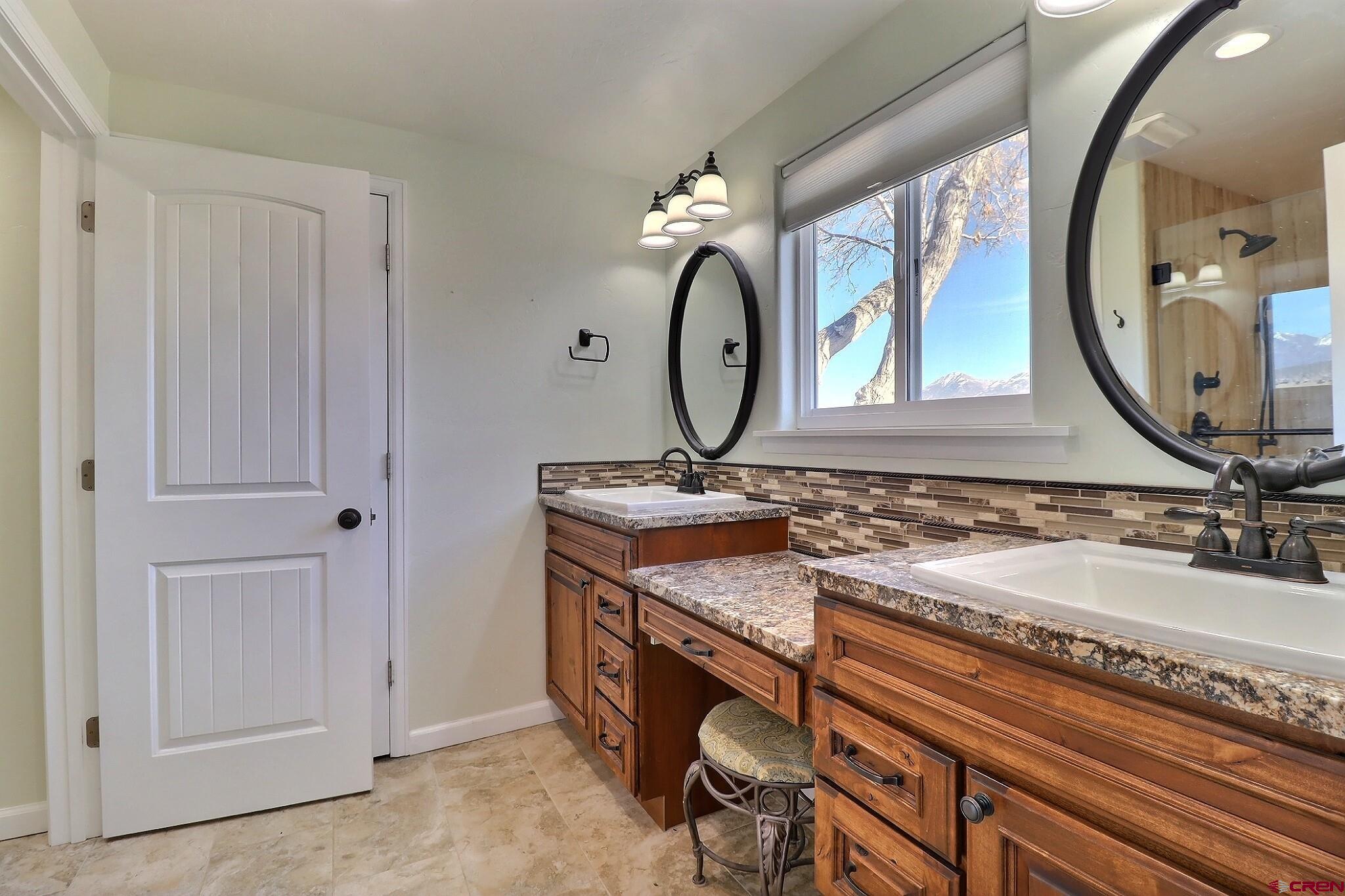 36557 Grandview Mesa Road Crawford, CO 81415 - Photo 20 of 45 a bathroom with a double vanity sink and a mirror