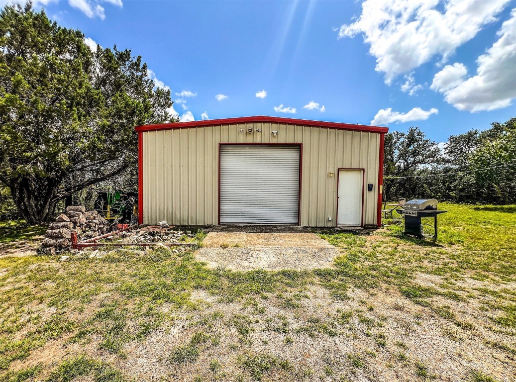 1220 County Road 225 Briggs, TX 78608 - Photo 11 of 36 a view of yellow house with a yard