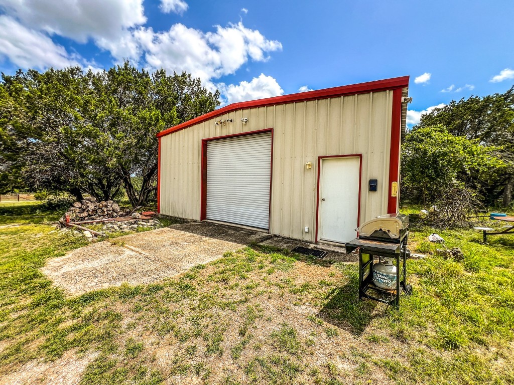1220 County Road 225 Briggs, TX 78608 - Photo 13 of 36 a backyard of a house with table and chairs