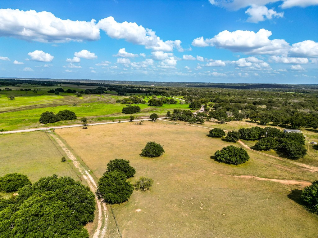 1220 County Road 225 Briggs, TX 78608 - Photo 26 of 36 a view of a swimming pool with an outdoor space and seating area