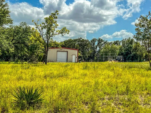a view of yellow house with a yard