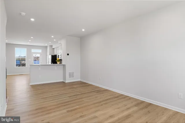 a kitchen with stainless steel appliances a stove a sink a refrigerator a microwave and cabinets