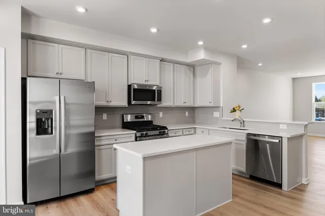 a kitchen that has a lot of cabinets in it and appliances