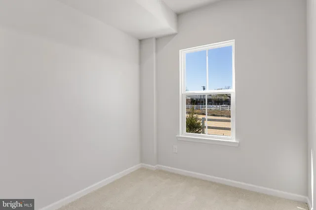 a view of a hallway with closet and bathroom