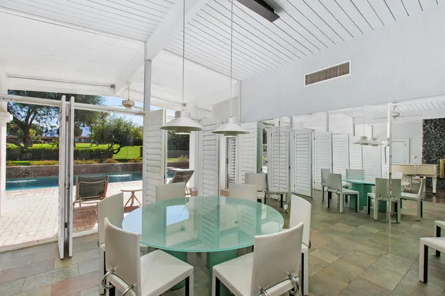 a dining table tennis pool with a large windows