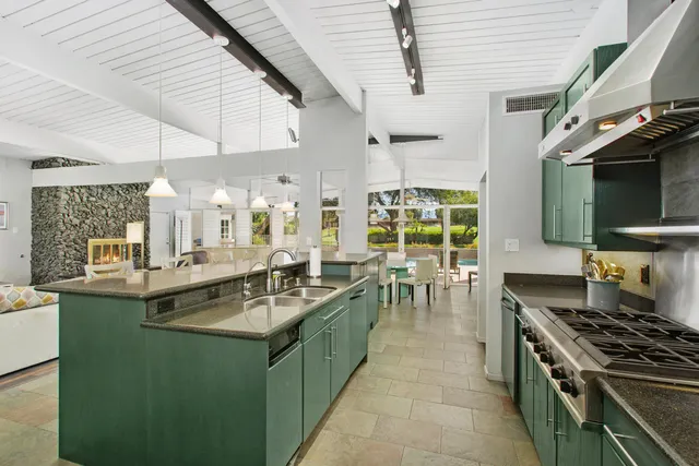 a kitchen with a sink and a stove top oven