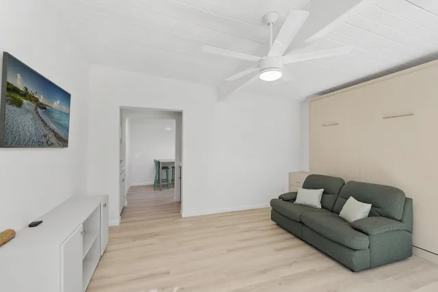 a large bed sitting in a bedroom next to a window