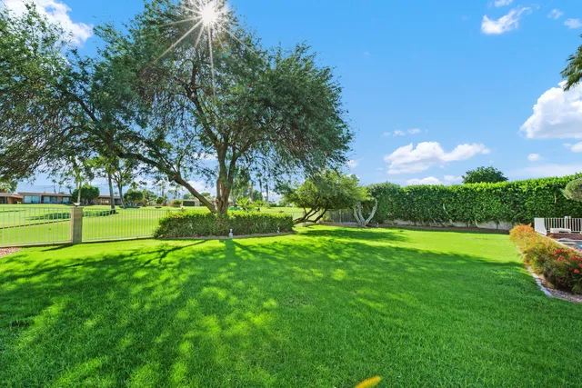 a front view of a house with a garden and plants
