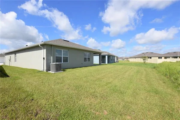 a view of a house with backyard and garden