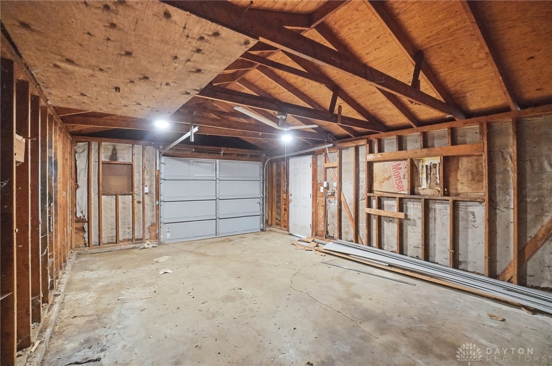 1923 Portage Path Springfield, OH 45506 - Photo 40 of 40 A spacious, bare-bones garage with exposed wooden beams and a new garage door, ready for your customization.