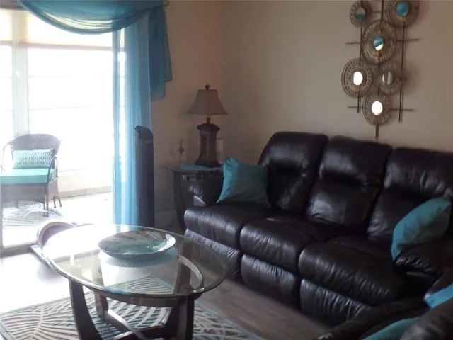 a living room with furniture and a mirror