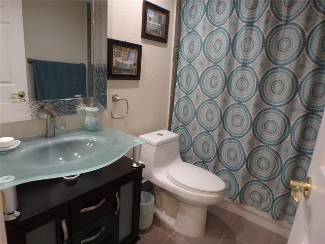 a bathroom with a toilet a sink and a mirror