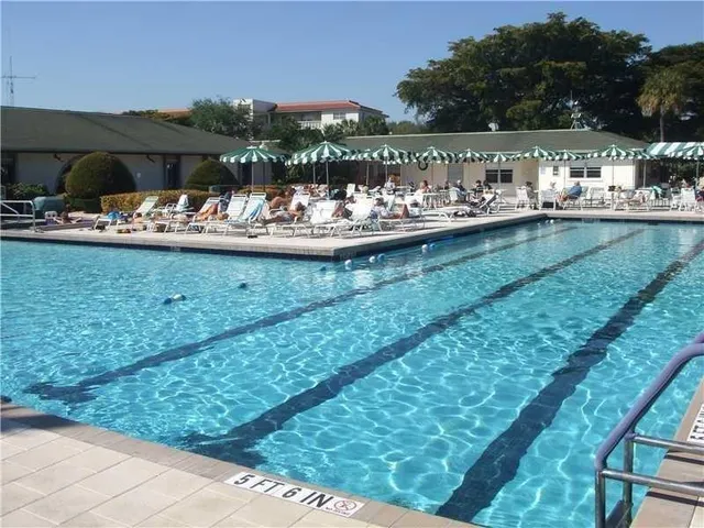 a view of a house with swimming pool and sitting area