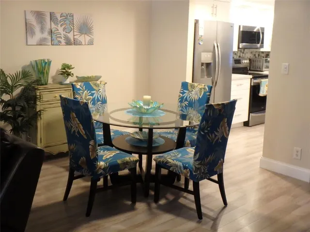 a living room with furniture a dining table and a chandelier