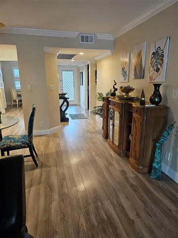 a view of a room with a window and furniture