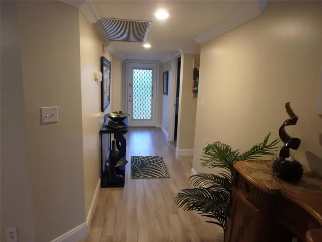 a table with a vase and paintings on it