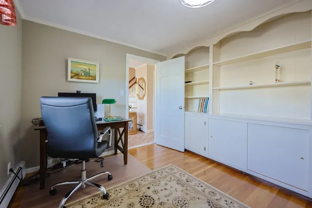 a view of a workspace with furniture and wooden floor