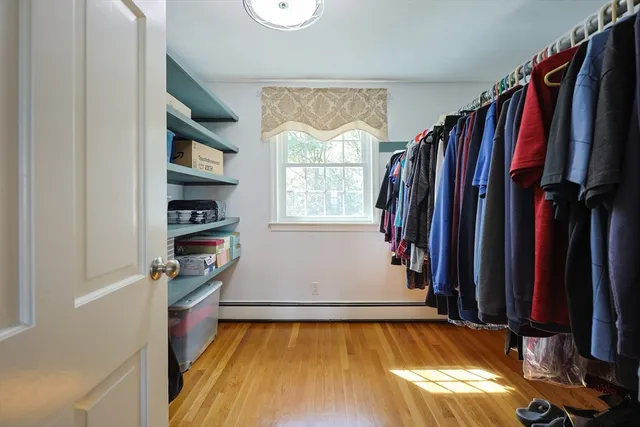 a view of walk in closet with clothes and shoes