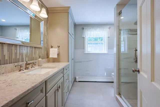 a bathroom with a granite countertop sink mirror and double