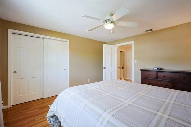 a bedroom with a large bed and a chandelier