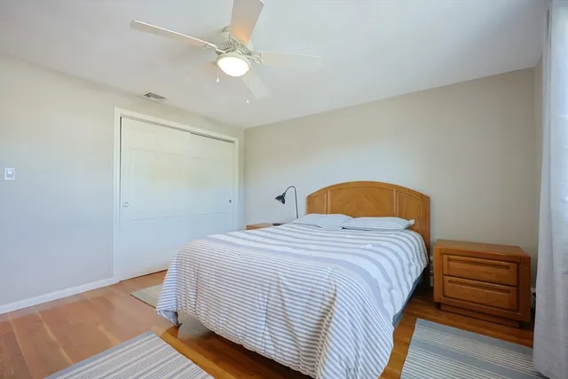 a bedroom with a bed and a ceiling fan