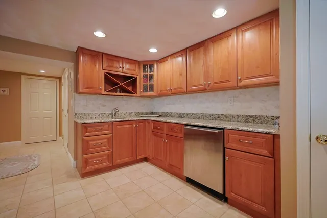 a kitchen with granite countertop a sink and a stove top oven