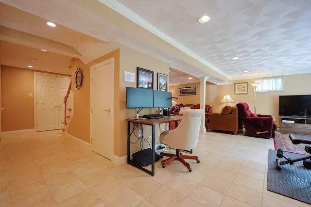 a view of a livingroom with workspace and a window