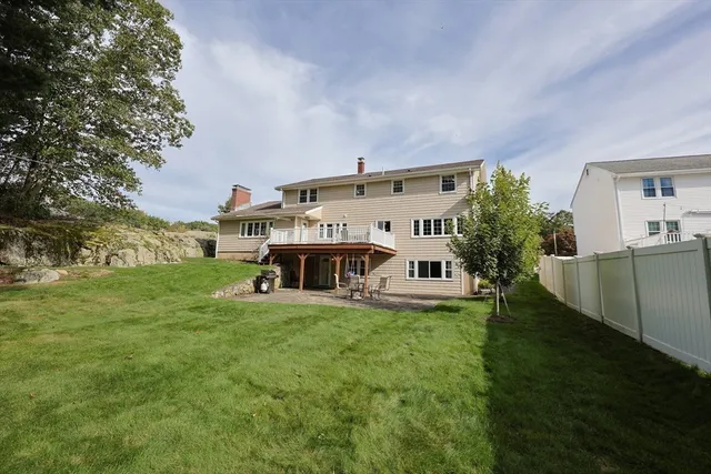 a view of a house with a big yard and large trees