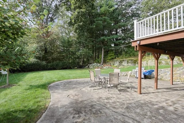 a view of a chair and table in the garden