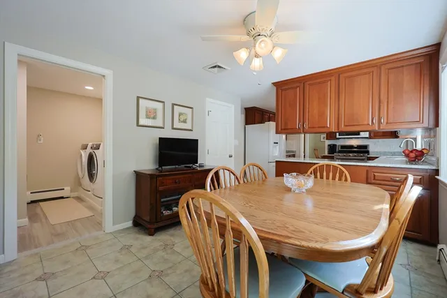 a dining room with furniture a window and a chandelier