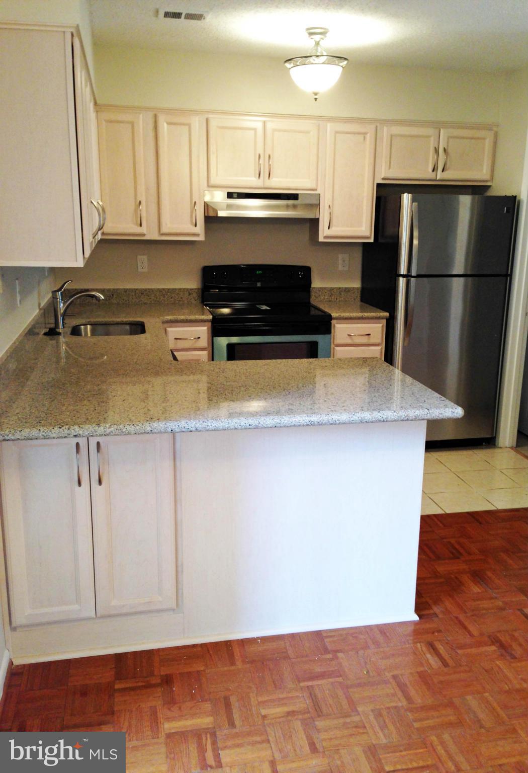 2232 White Cornus Lane Reston, VA 20191 - Photo 6 of 25 a kitchen with a refrigerator and a stove